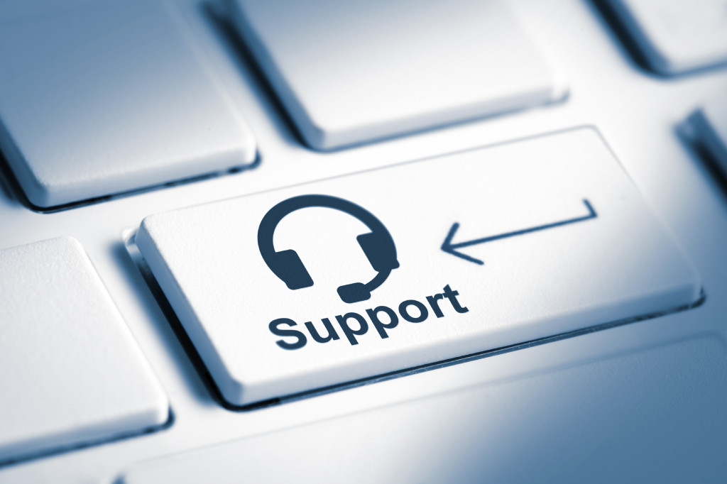 Support text and headset icon with enter key on computer keyboard, business and tech concept